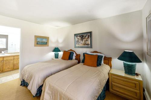 a bedroom with two beds and a table with a lamp at Snowmas Village 5AB in Snowmass Village