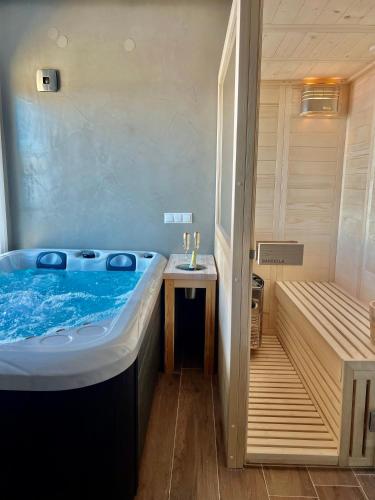 a large bath tub in a bathroom with a sink at Nayra View & Spa in Kavála