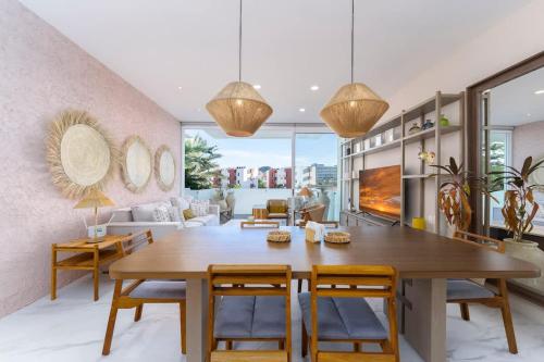 a dining room with a wooden table and chairs at 3BR Apartment Beach & Dining Steps Away in Cabo San Lucas