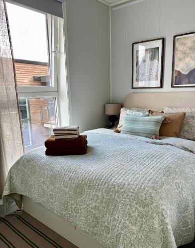 a white bedroom with a bed and a window at Mountain and Sea View Svolvær in Svolvær