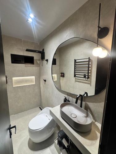 a bathroom with a sink and a mirror at Arcoverde - Varanda com Vista Panorâmica - excelente localização - até 6 pessoas in Arcoverde
