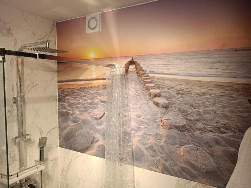 a shower in a bathroom with the ocean at Azyl in Darłówko