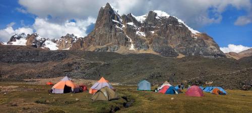 a group of tents in front of a mountain at Selena Camping in Tayapampa