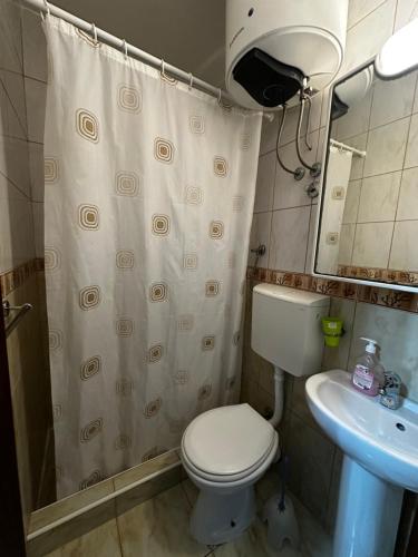 a small bathroom with a toilet and a sink at Villa primorka in Boreti