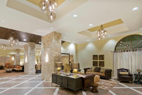 a lobby of a hotel with couches and chairs at Crowne Plaza Albuquerque by IHG in Albuquerque