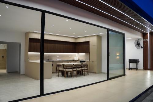 a dining room and kitchen seen through a window at Lakeside Palms in Tirana