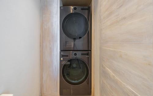 a washer and dryer in a corner of a room at LuxVilla Modern Beachfront in the Village in Caye Caulker