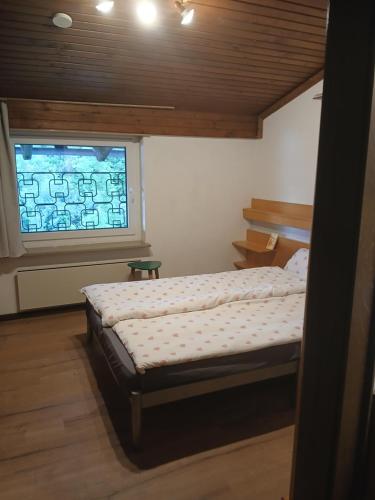 a small bedroom with a bed and a window at Apartment Lilla in Millstatt