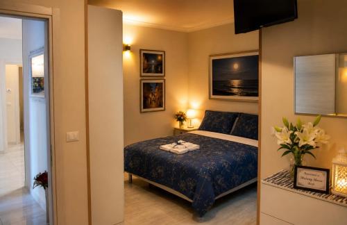 a bedroom with a bed with a blue comforter at Midway House Italy in Sant'Egidio del Monte Albino