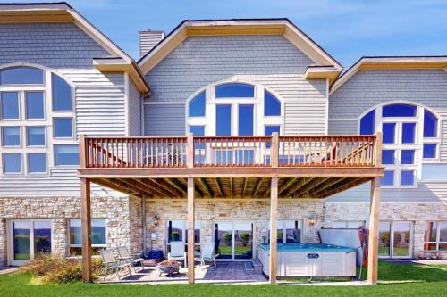 a house with a deck with a hot tub at Amazing Overlook in McHenry