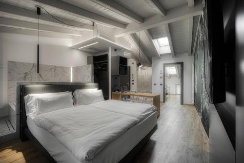 a bedroom with a large white bed in a room at M Loft - adults only in Malcesine