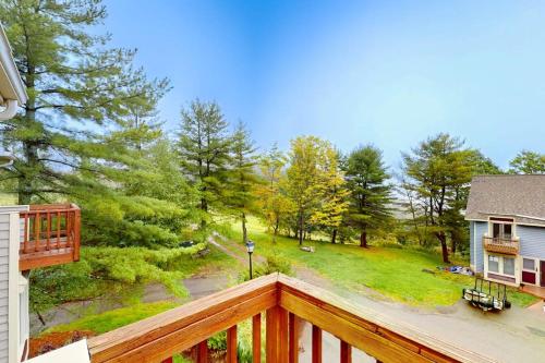 a wooden balcony with a view of a yard at Stella's Retreat in McHenry