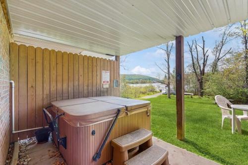 a hot tub sitting under a tent on a porch at Ski Cove #2 in McHenry