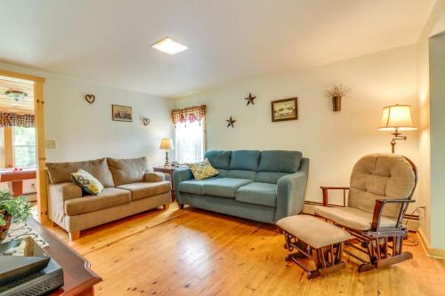 a living room with a couch and a chair at Still Meadows in Oakland