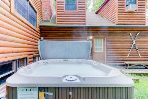 a large hot tub in front of a house at Lazy Bear Lodge in Swanton