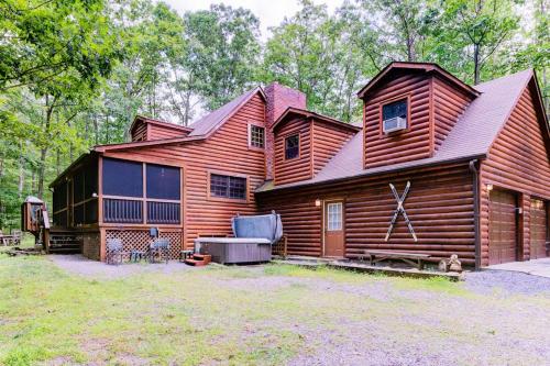 a wooden cabin with a gambrel roof at Lazy Bear Lodge in Swanton