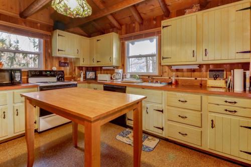 a kitchen with wooden cabinets and a wooden table at Pee Wee Acres in Swanton