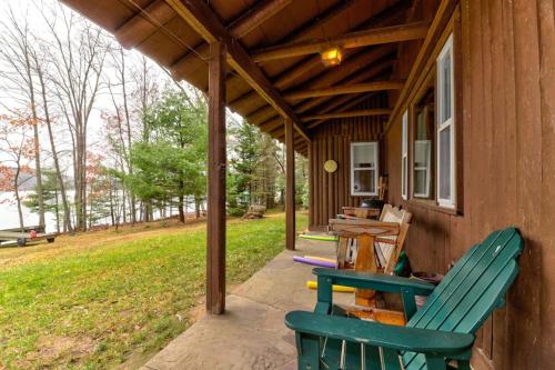 a porch of a house with two chairs and a table at Pee Wee Acres in Swanton
