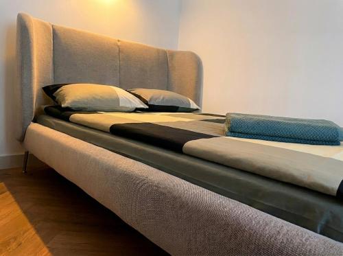 a large bed with two pillows on top of it at Oru Park & Sea Apartment in Tallinn