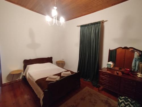 a bedroom with a bed and a dresser and a mirror at Αιθεροβάμων - Etherovamon in Areopoli