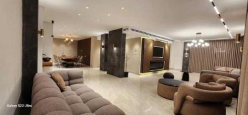 a large living room with a couch and chairs at שובל shoval in Yavneʼel