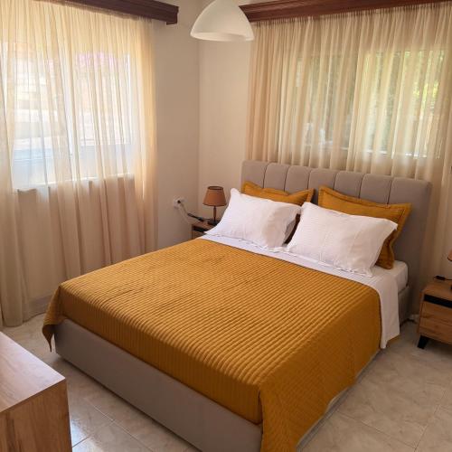 a bedroom with a large bed and a window at Olea House in Alexandroupoli