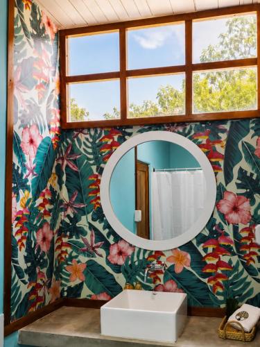 a bathroom with a mirror and a sink at CasaBosque in Tarapoto