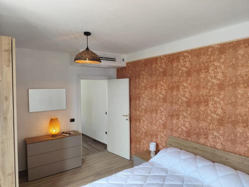 a bedroom with a bed and a wall at B&B Vuiariello in Montefusco