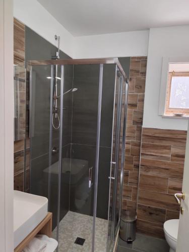 a shower with a glass door in a bathroom at B&B Vuiariello in Montefusco