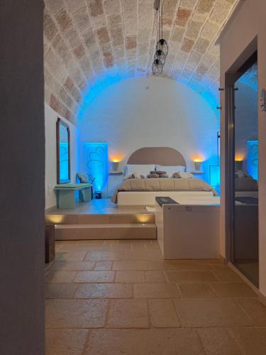 a bedroom with a bed with a blue ceiling at Le Perle di Bà - Suites with Jacuzzi in Polignano in Polignano a Mare