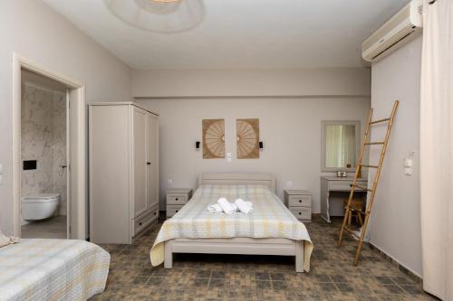 a bedroom with a bed with two towels on it at Kastalia Studios And APARTMENTS in Skala Potamias