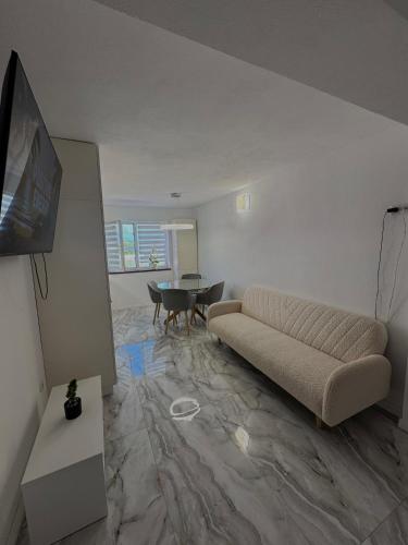 a living room with a couch and a table at Apartament Deluxe in Orăştie