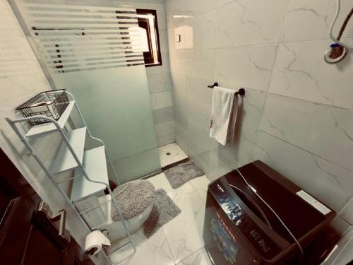 a bathroom with a sink and a shower with a mirror at private studio - djorff area in Al Aqālitah