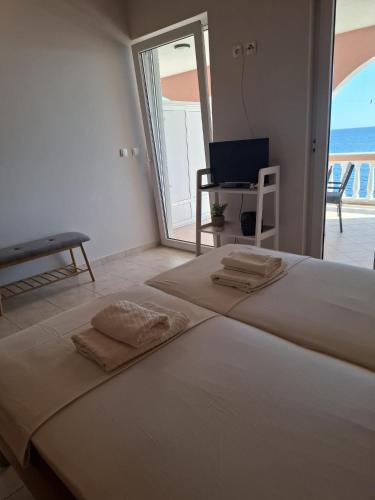 a bedroom with a bed with two towels on it at Apartments Maskovic Karbuni in Prizba