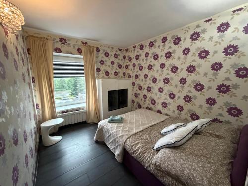 a bedroom with a bed and a tv at Glow Rooms in Gdynia