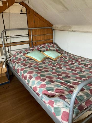 a bed with two pillows on it in a room at Brothers Homestay in Best