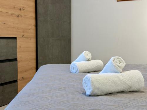 a room with a bed with towels on it at Eva's Penthouse with private Swimming pool by ELDI in Il-Gżira