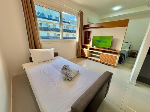 a room with a bed and a television in it at Maxplaza Residential 1209 in Canoas