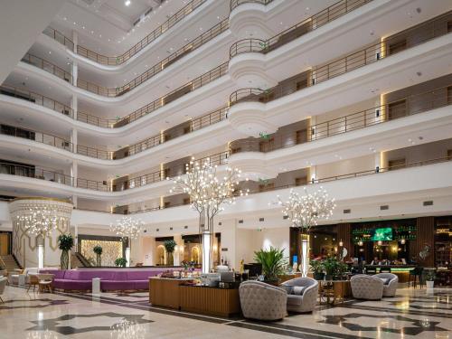 a lobby of a hotel with a large building at Mövenpick Samarkand in Samarkand