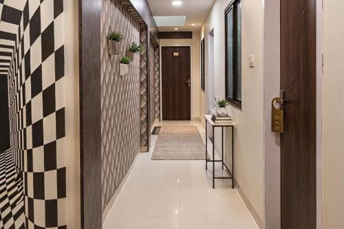 a hallway of a house with black and white tiles at Hotel Venus Inn in Indore
