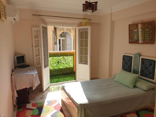 a bedroom with a bed and a door to a yard at Apartment Alexandria City Center in Alexandria