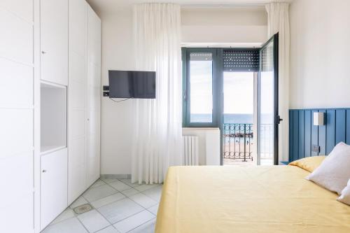 a bedroom with a bed and a view of the ocean at Affittacamere Prima Fila Mare in Porto Recanati