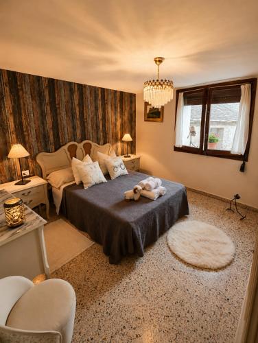 a bedroom with a bed with a teddy bear on it at Casa Rural Pablo in Ara