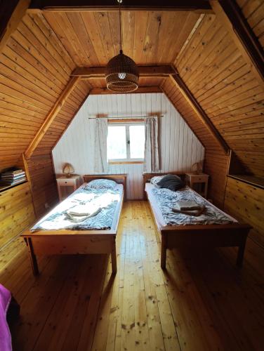 a bedroom with two beds in a attic at Chata Radostín in Radostín
