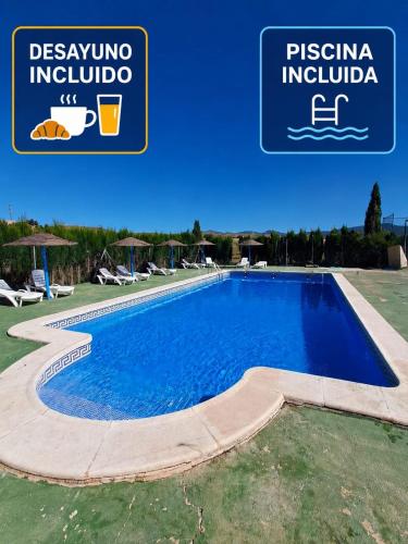 a swimming pool in a resort with a sign that reads piscina inclula at Cortijo Ojos del Prado in Caravaca de la Cruz