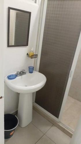 a bathroom with a white sink and a shower at Marina Diamante - Ilse C in Acapulco