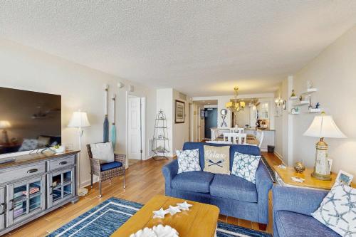 a living room with a blue couch and a table at Sea Colony - 604 Dover House Rd. in Bethany Beach