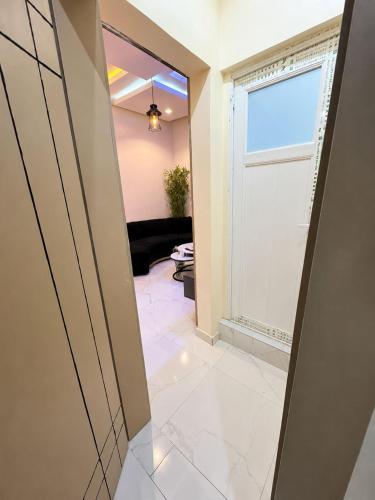 a hallway with a door and a living room at Leebwill Hotel & Apartment in Eku