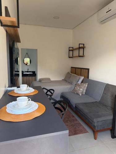 a living room with a table and a couch at Loft Vip RR in Boa Vista