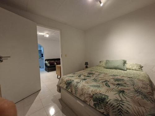 a bedroom with a large bed in a white room at Casa de Férias Palmeira in Faro